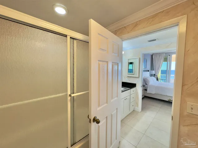 a spacious bathroom with a granite countertop sink a toilet a mirror and a shower