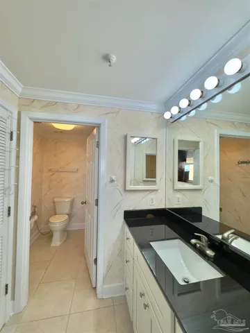 a bedroom with two beds and painting on the wall