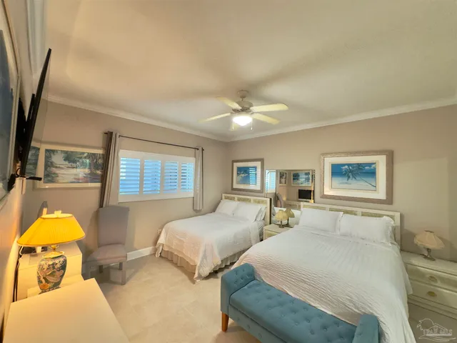 a bedroom with two beds and a chandelier