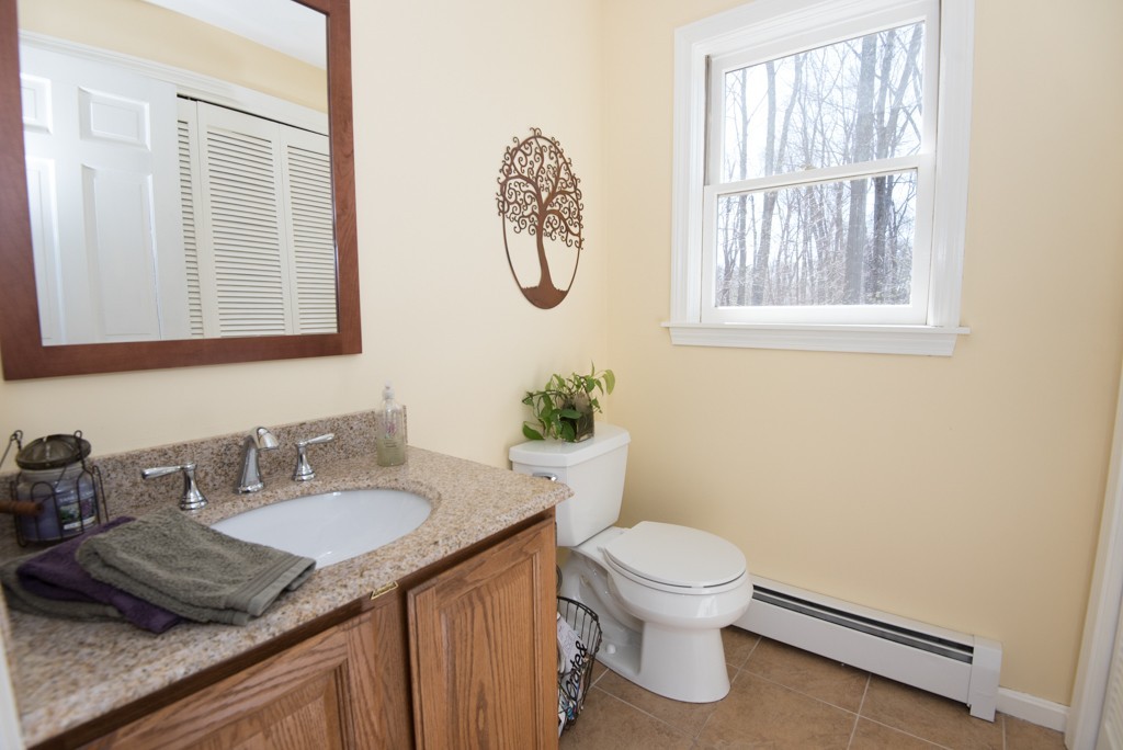 35 Acorn Road Northbridge, MA 01588 - Photo 9 of 23 a bathroom with a granite countertop sink a toilet and a window