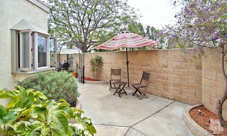 2921 Fanshell Walk Oxnard, CA 93035 - Photo 14 of 20 a view of a patio with table and chairs under an umbrella