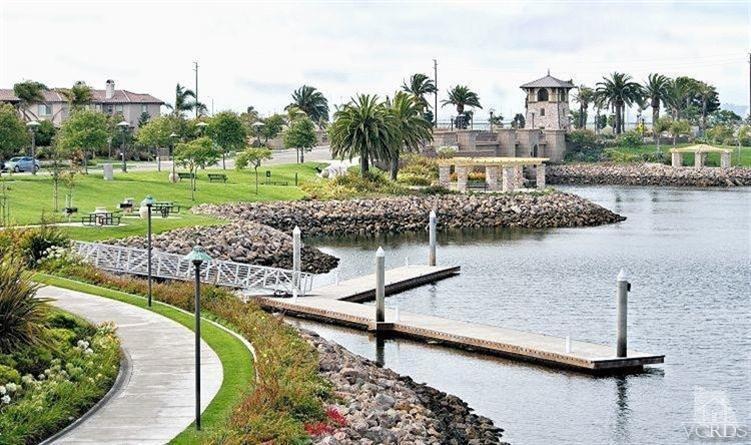 2921 Fanshell Walk Oxnard, CA 93035 - Photo 19 of 20 a view of a lake with a yard and large trees