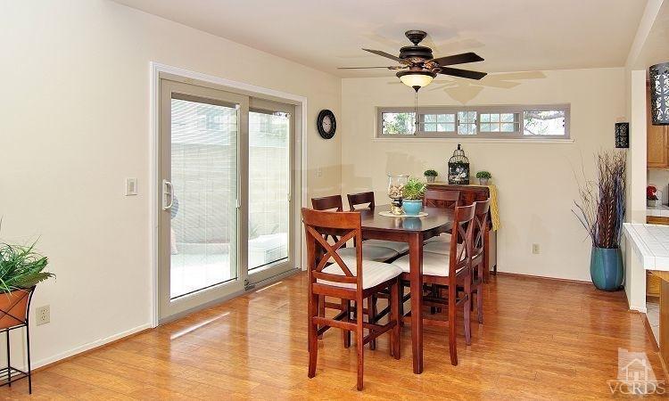 2921 Fanshell Walk Oxnard, CA 93035 - Photo 5 of 20 a dining room with furniture a floor to ceiling window and wooden floor