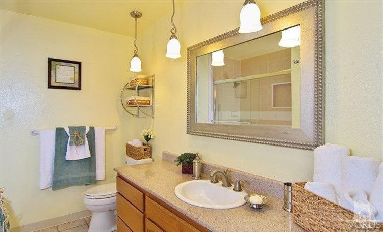 2921 Fanshell Walk Oxnard, CA 93035 - Photo 8 of 20 a bathroom with a granite countertop sink mirror and toilet