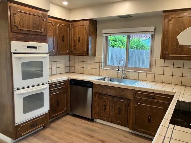 a kitchen with a sink stove and cabinets