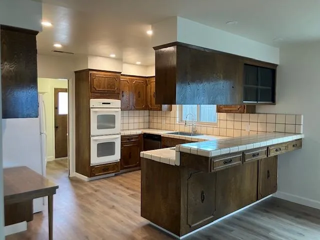 a kitchen with stainless steel appliances wooden cabinets and sink