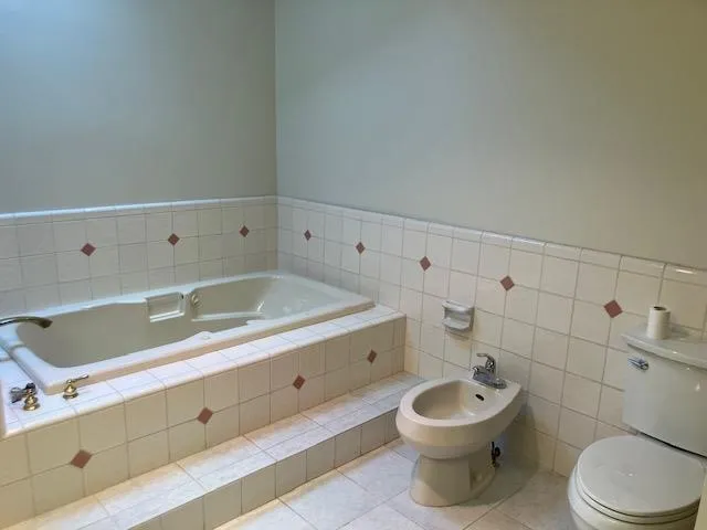 a bathroom with a toilet a sink and a shower