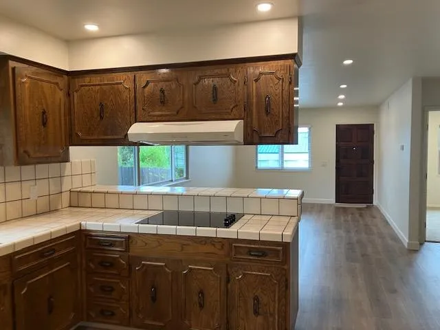 a kitchen with a sink cabinets and wooden floor