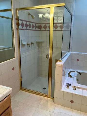 a bathroom with a shower and a sink