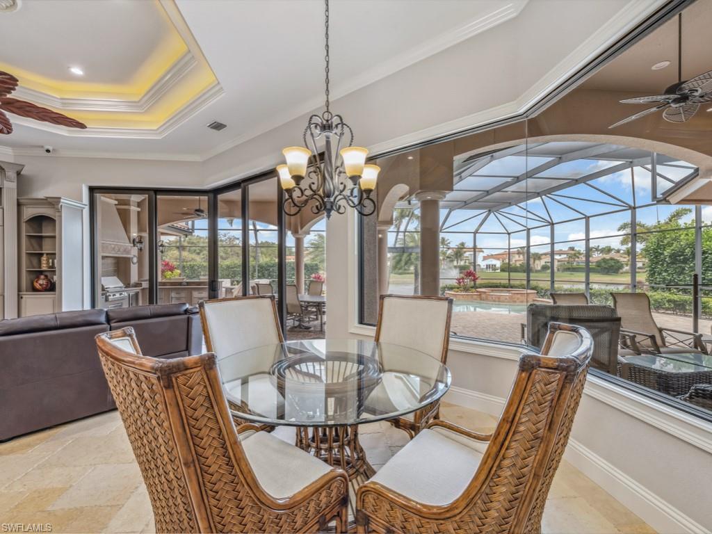 16509 Cellini Lane Naples, FL 34110 - Photo 11 of 49 a dining room with furniture a chandelier and large windows