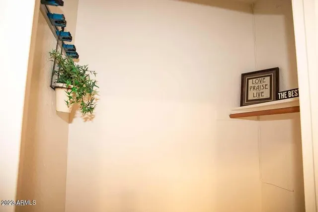 a view of a small space with wooden floor and a window