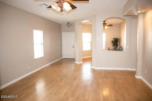 wooden floor in an empty room with a window