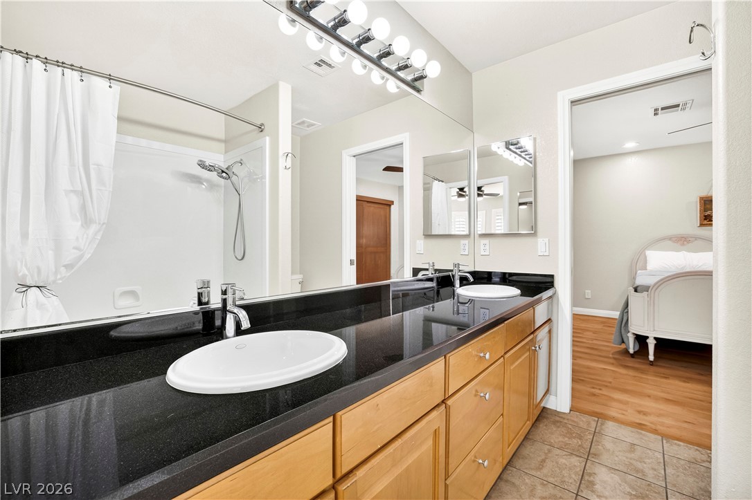 1135 Calico Ridge Drive Henderson, NV 89011 - Photo 41 of 86 Double vanities and a tub/shower create a functional and pleasant bathroom. This is a Jack & Jill between the 2nd and 3rd bedrooms upstairs.