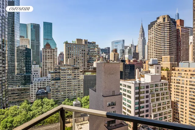 a dining room with wooden floor a chandelier a wooden table and chairs