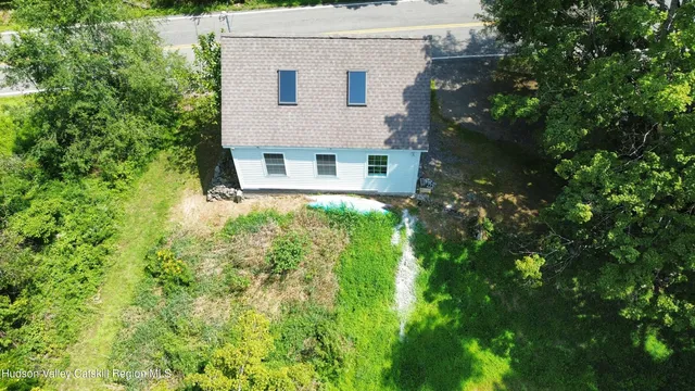 an aerial view of house with yard