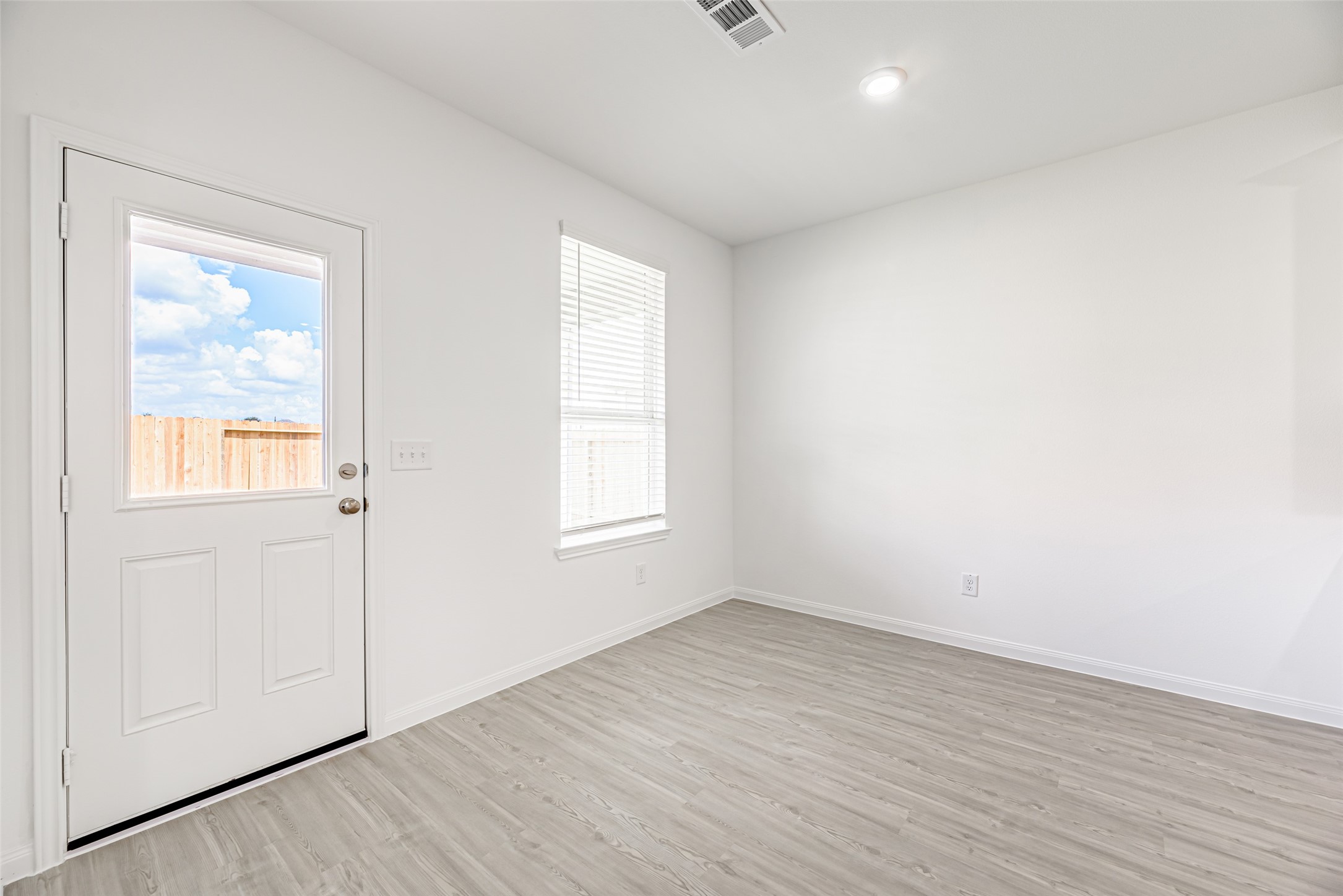 23422 Wagon Cart Road Hockley, TX 77447 - Photo 10 of 28 an empty room with wooden floor and windows