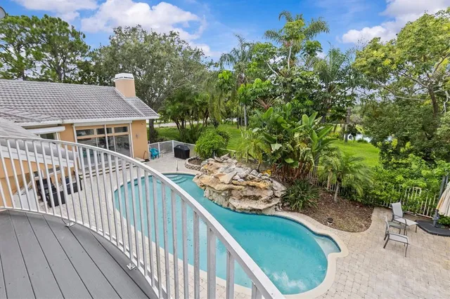 a kitchen with stainless steel appliances kitchen island granite countertop a sink and cabinets