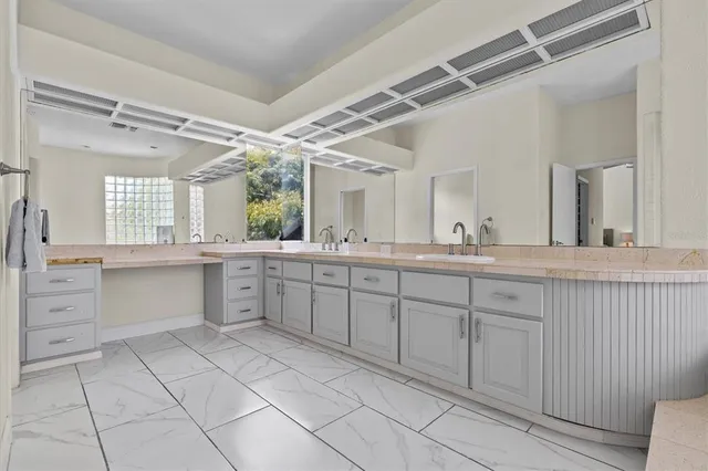 a kitchen with granite countertop a sink a stove and cabinets