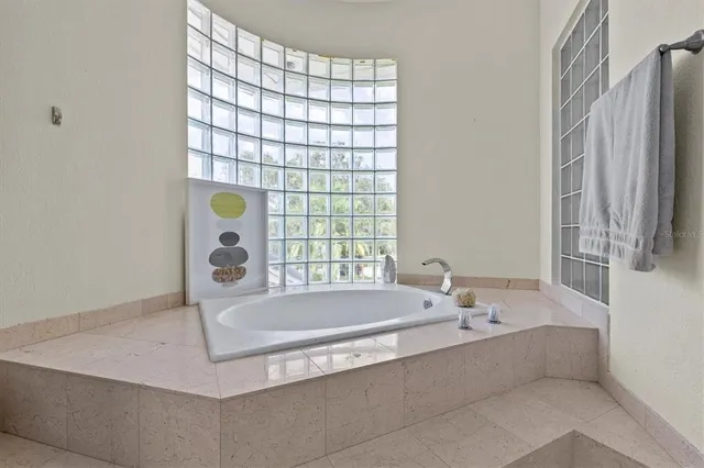 a kitchen with granite countertop a sink and white cabinets