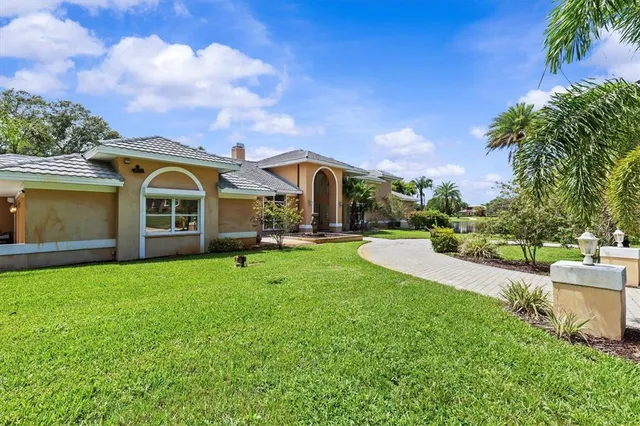 an aerial view of a house with outdoor space and lake view