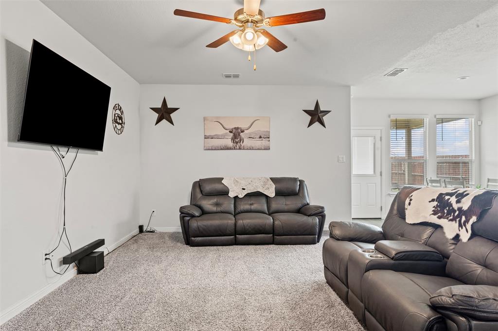 1104 Dublin Drive Cleburne, TX 76033 - Photo 11 of 39 Carpeted living area with a ceiling fan and baseboards