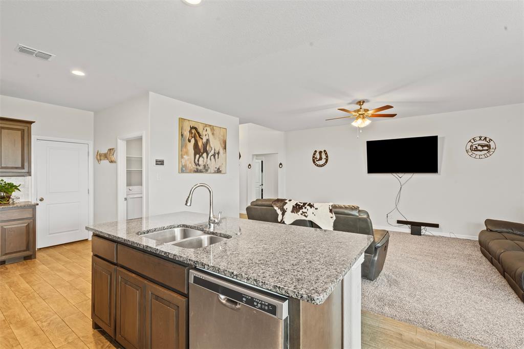 1104 Dublin Drive Cleburne, TX 76033 - Photo 39 of 39 Kitchen featuring open floor plan, dishwasher, light stone countertops, light wood-style flooring, and recessed lighting