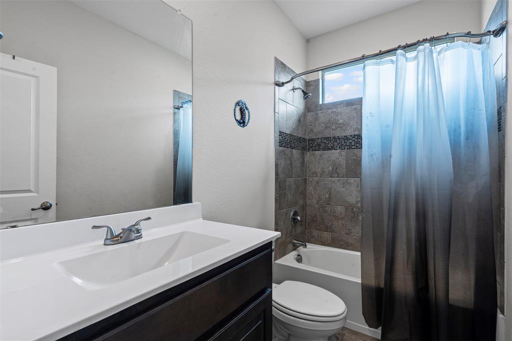 1104 Dublin Drive Cleburne, TX 76033 - Photo 16 of 39 Full bathroom featuring shower / bath combo, vanity, and a textured wall