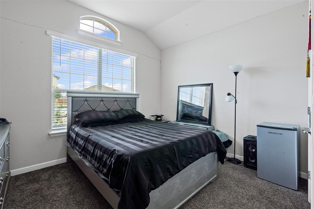 1104 Dublin Drive Cleburne, TX 76033 - Photo 17 of 39 Bedroom featuring vaulted ceiling and dark colored carpet