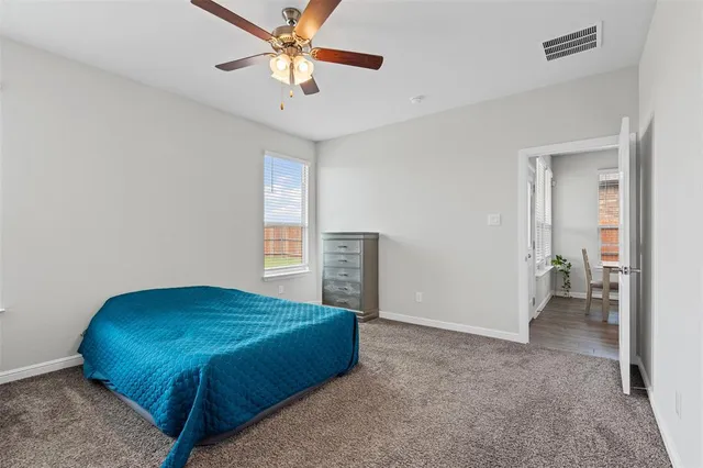 a bedroom with bed and window
