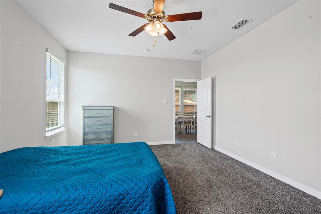 1104 Dublin Drive Cleburne, TX 76033 - Photo 22 of 39 Carpeted bedroom featuring baseboards and a ceiling fan