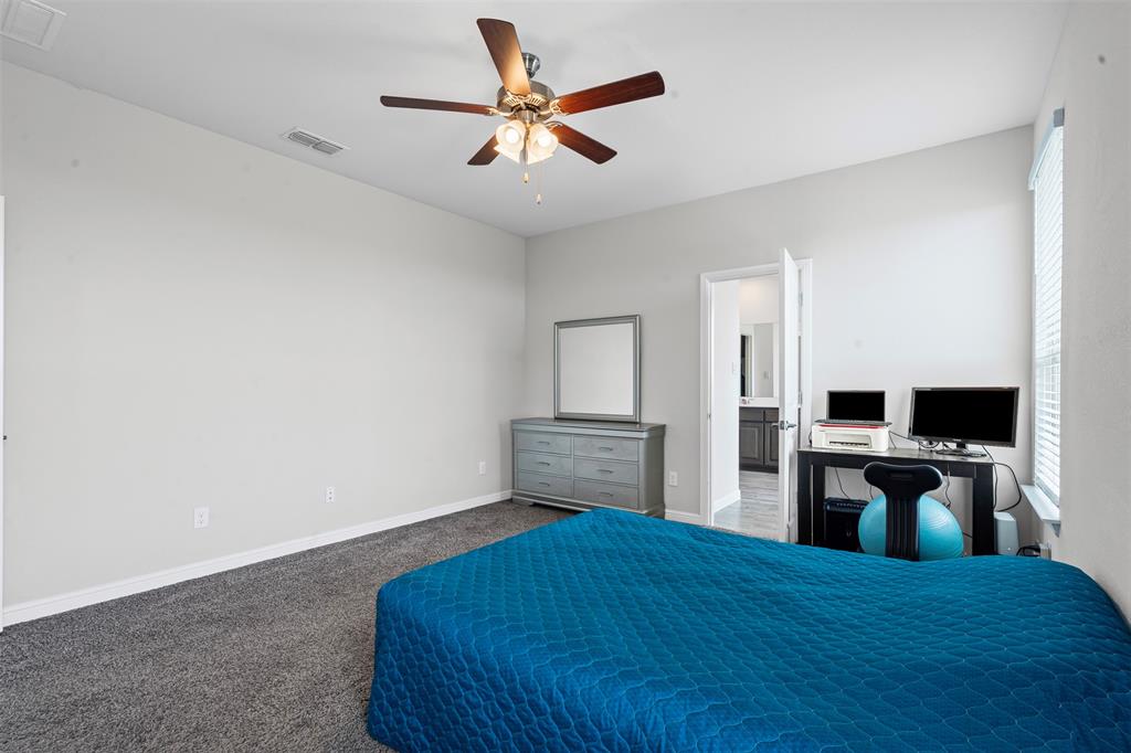 1104 Dublin Drive Cleburne, TX 76033 - Photo 23 of 39 Carpeted bedroom with ceiling fan and ensuite bathroom