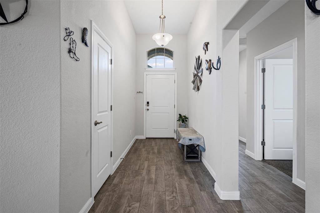 1104 Dublin Drive Cleburne, TX 76033 - Photo 7 of 39 Foyer entrance with dark wood finished floors and baseboards