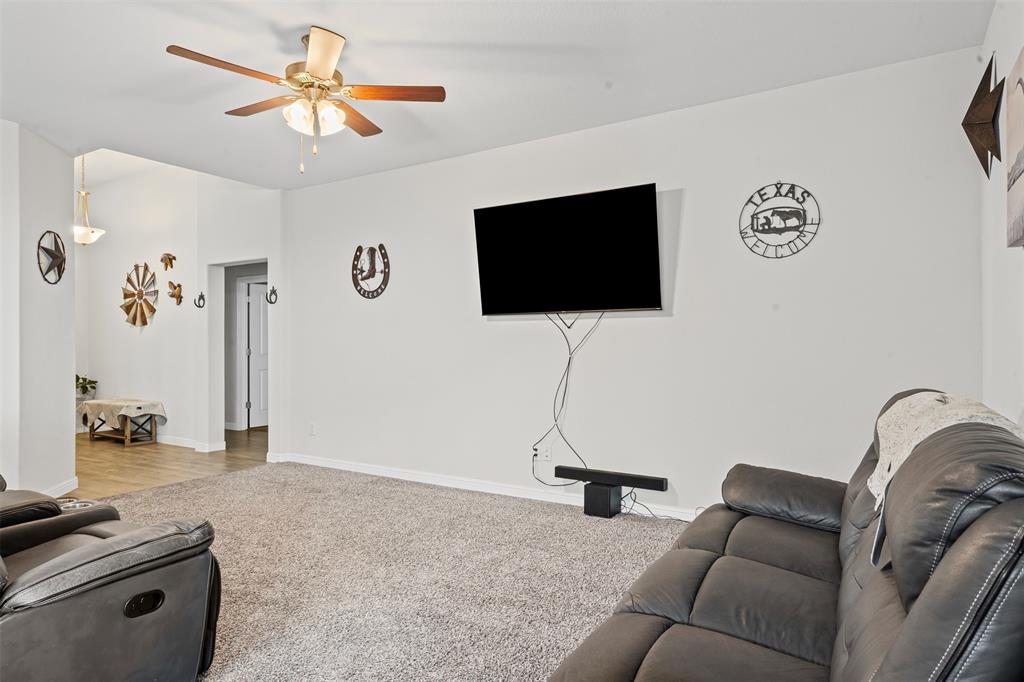 1104 Dublin Drive Cleburne, TX 76033 - Photo 9 of 39 Living area with carpet floors and ceiling fan