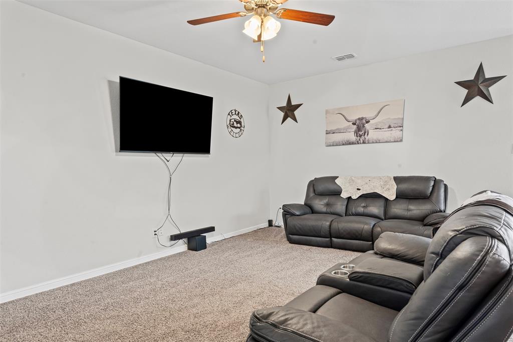1104 Dublin Drive Cleburne, TX 76033 - Photo 10 of 39 Carpeted living area featuring baseboards and ceiling fan
