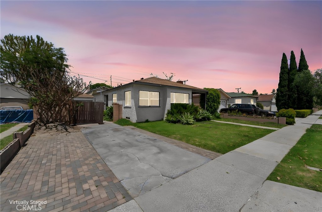 2725 East Tyler Street Carson, CA 90810 - Photo 2 of 30 a front view of a house with a yard and potted plants