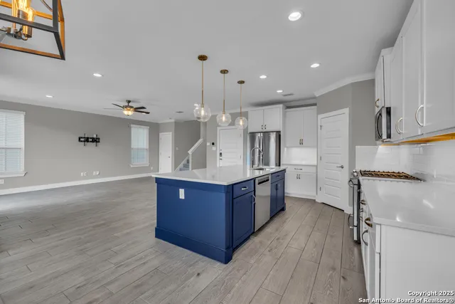 a kitchen with a sink a counter space and a window