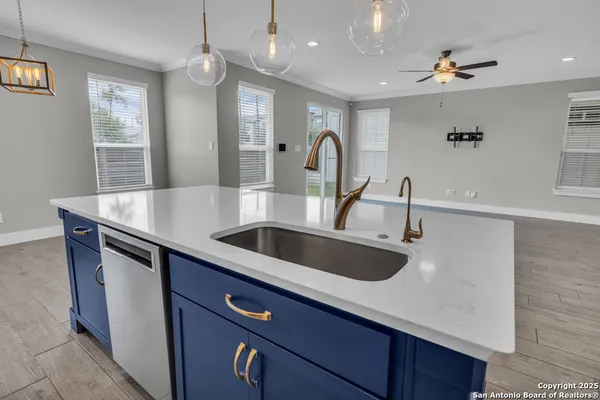 a kitchen with stainless steel appliances a sink and a refrigerator