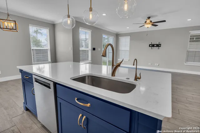 a kitchen with stainless steel appliances a sink and a refrigerator