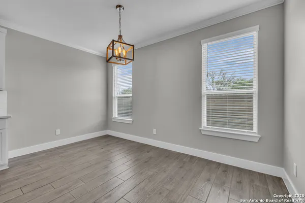 a view of hallway with stairs and wooden floor