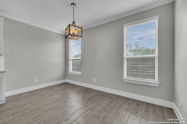 a view of hallway with stairs and wooden floor