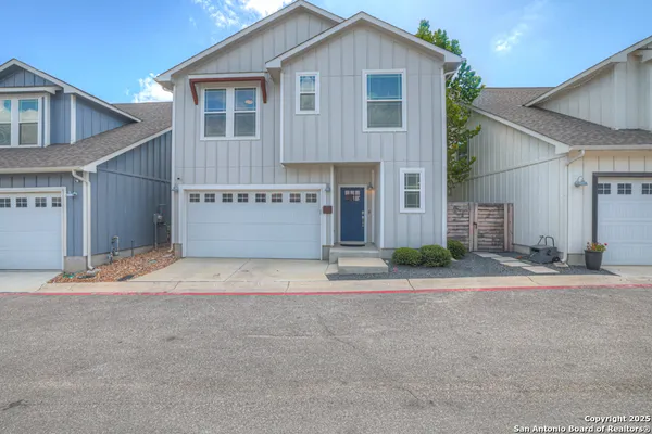 a front view of a house with a yard and a garage