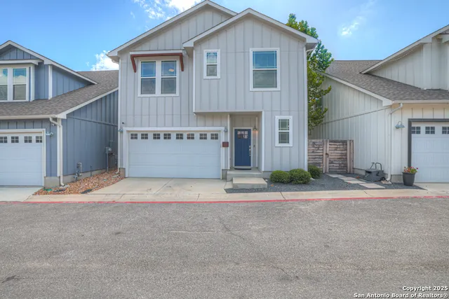 a front view of a house with a yard and a garage