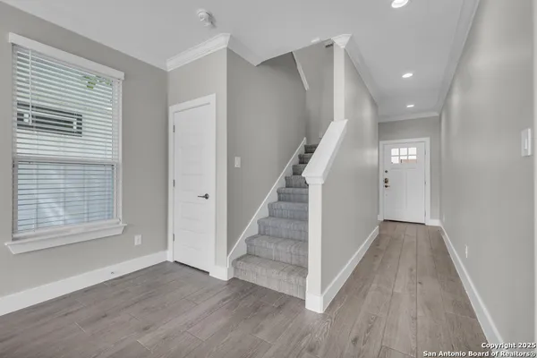 a view of staircase with white walls and a window