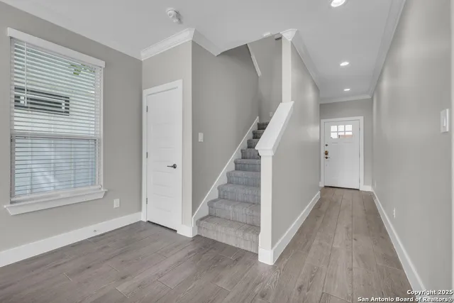 a view of staircase with white walls and a window