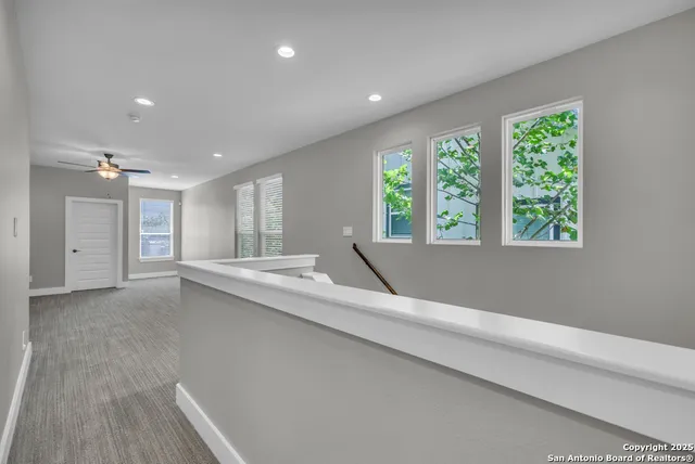 an empty room with closet and ceiling fan