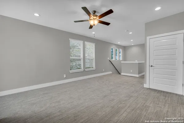 an empty room with closet and ceiling fan