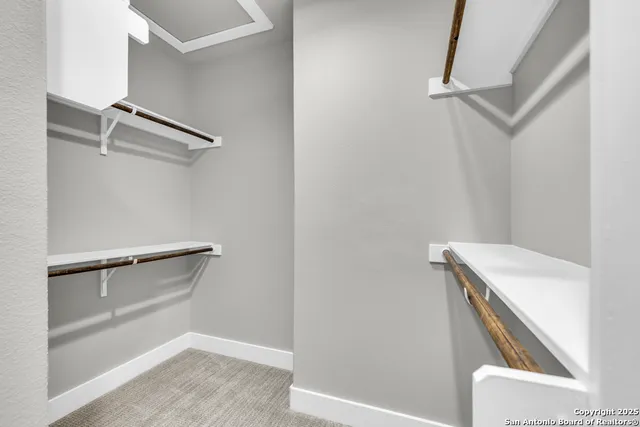 a bathroom with a granite countertop toilet a sink a mirror and shower