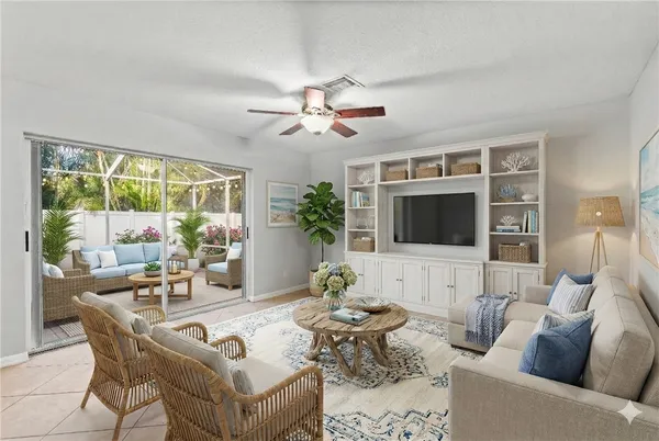 a living room with furniture a flat screen tv and a large window