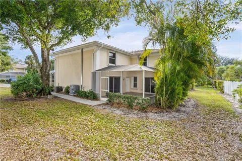 a view of a house with backyard and trees