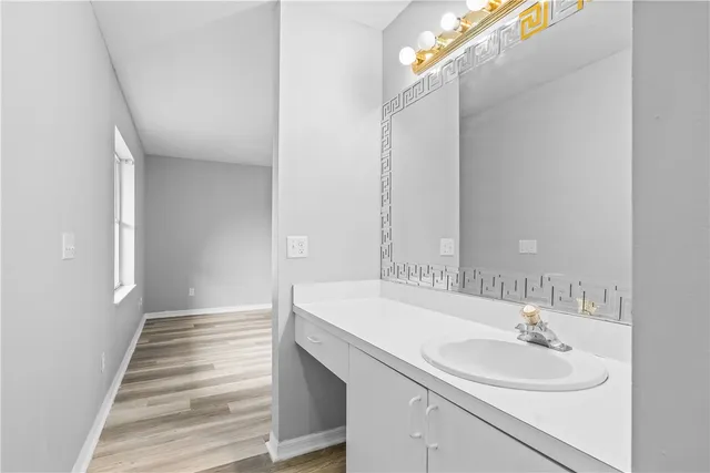 a view of a hallway with wooden cabinets and front door